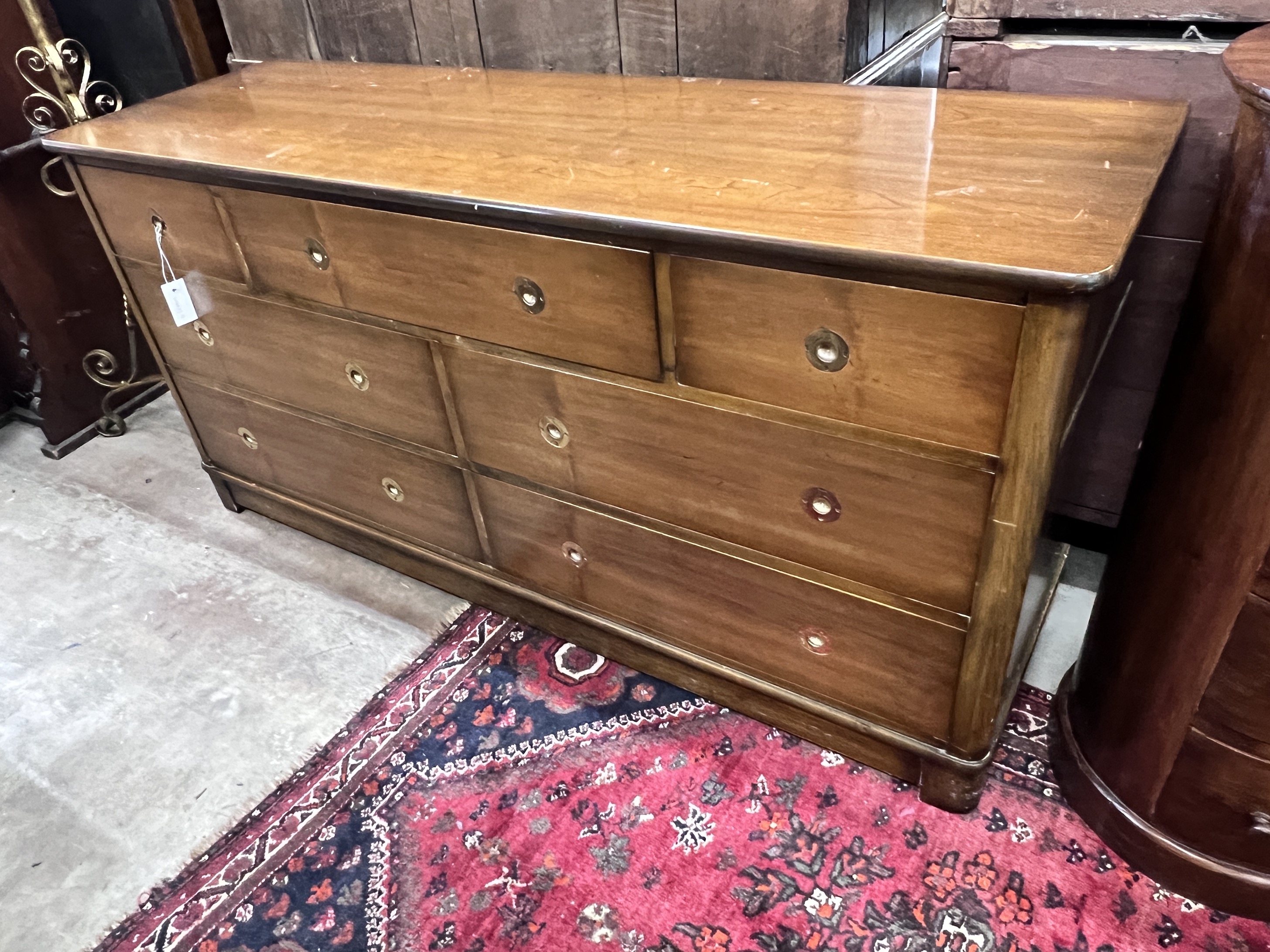A reproduction mahogany military style dresser fitted seven small drawers, with recessed brass handles, width 153cm, depth 48cm, height 74cm